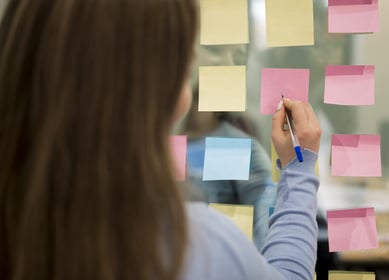 back-view-woman-office-writing-sticky-notes